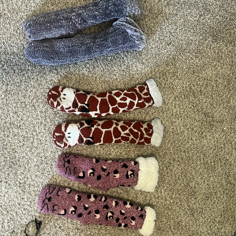 three pairs of fluffy socks plain gray pair, giraffe pair, and a cat pair
